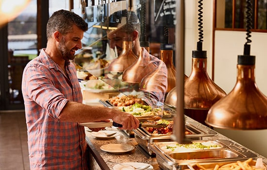 links-gallery-image-country-club-links-buffet-man-selecting-food-550x350